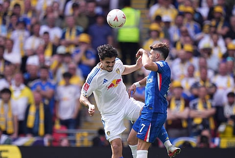 Leeds' Pascal Struijk vies for the ball with Chelsea's Pedro Neto, right, during the FA Cup semifinal soccer match between Chelsea and Leeds in London, England.