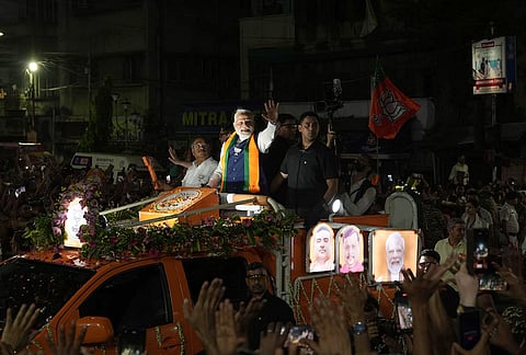 Prime Minister Narendra Modi greets supporters during a roadshow, amid the ongoing West Bengal Assembly elections, in Kolkata.