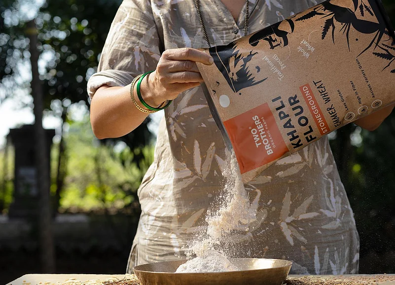 Pouring Two Brothers Khapli Wheat Flour into a bowl
