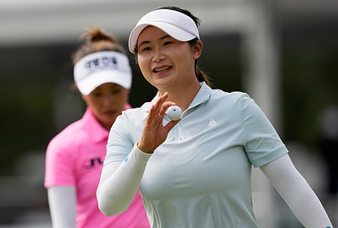 Yan Liu, of China, celebrates after a birdie on the 18th hole during the final round of the Chevron Championship LPGA golf tournament in Houston.