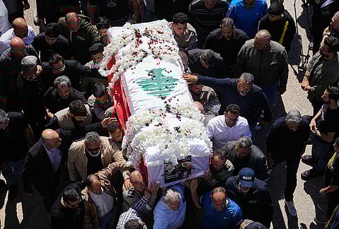 Mourners carry the coffin of Lebanese journalist Amal Khalil, who was killed Wednesday in an Israeli airstrike, during her funeral procession in the village of Baysariyeh in southern Lebanon on Thursday, April 23, 2026. 