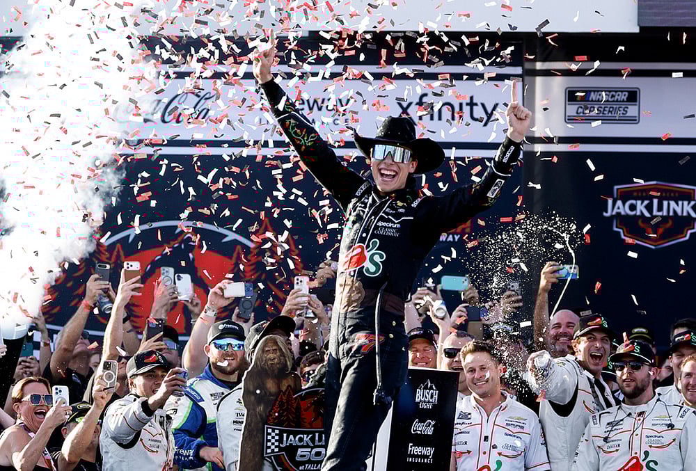 | Photo: AP/Butch Dill : Carson Hocevar celebrates after winning a NASCAR Cup Series auto race, in Talladega, Alabama. 