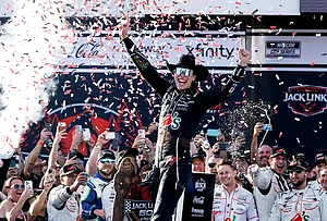 | Photo: AP/Butch Dill : Carson Hocevar celebrates after winning a NASCAR Cup Series auto race, in Talladega, Alabama.