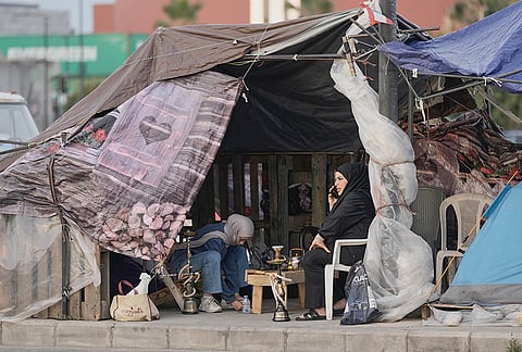 Displaced people who fled Israeli strikes in southern Lebanon sit inside a shelter tent in Beirut, Lebanon, Friday, April 24, 2026. 