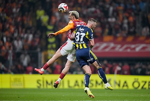 Galatasaray's Baris Yilmaz, left, goes for a header with Fenerbahce's Milan Skriniar during a Turkish Super Lig soccer match between Galatasaray and Fenerbahce in Istanbul, Turkey.