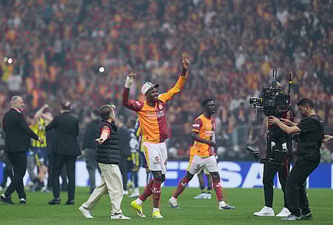 Galatasaray's players celebrate at the end of a Turkish Super Lig soccer match between Galatasaray and Fenerbahce in Istanbul, Turkey.