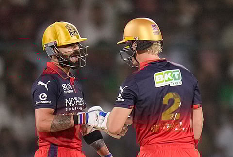 Royal Challengers Bengaluru's Virat Kohli and Jacob Bethell interact during the Indian Premier League (IPL) T20 cricket match between Delhi Capitals and Royal Challengers Bengaluru, in New Delhi.