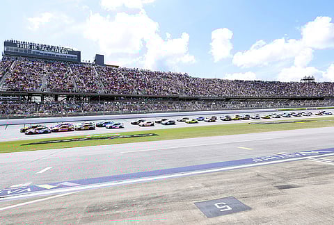 Tyler Reddick (45) and Kyle Larson (5) lead the pack to the start during a NASCAR Cup Series auto race in Talladega, Alabama.