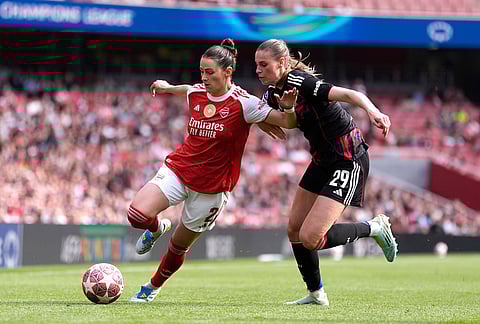 Arsenal's Emily Fox, left, and OL Lyonnes' Jule Brand, right, challenge for the ball during the Women's Champions League semi-final, first leg soccer match between Arsenal and OL Lyonnes in London, England.