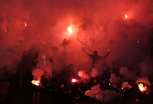 | Photo: AP/Darko Vojinovic : Partizan fans light fireworks during a Serbian National soccer league derby match between Red Star and Partizan in Belgrade, Serbia.