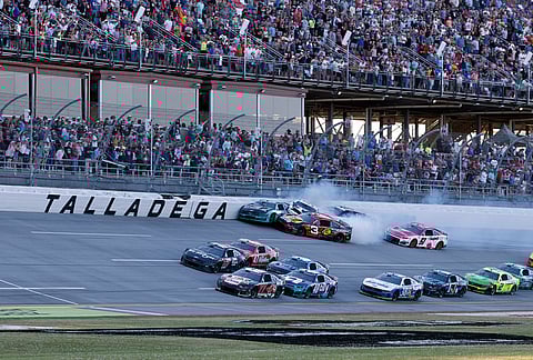 Carson Hocevar (77) leads the pack to the finish line as Ryan Preece (60), Austin Dillon (3), Christopher Bell (20), and Shane Van Gisbergen (97) wreck during a NASCAR Cup Series auto race, in Talladega, Alabama.