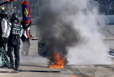 Ryan Preece (60) leaves a trail of fire as he pulls out of his pit during a NASCAR Cup Series auto race in Talladega, Alabama.
