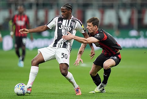 Juventus' Jonathan David, left, vies for the ball with AC Milan's Matteo Gabbia during a Serie A soccer match between AC Milan and Juventus, in Milan, Italy.