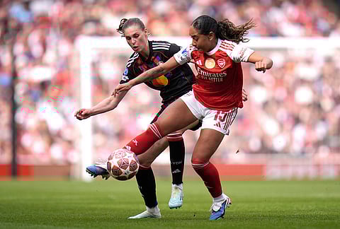Arsenal's Olivia Smith, right, and OL Lyonnes' Jule Brand, left, challenge for the ball during the Women's Champions League semi-final, first leg soccer match between Arsenal and OL Lyonnes in London, England.