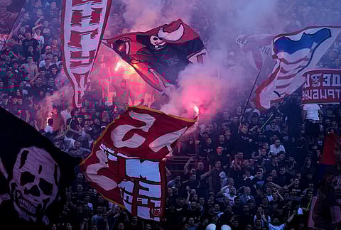 Red Star fans cheer during a Serbian National soccer league derby match between Red Star and Partizan in Belgrade, Serbia.