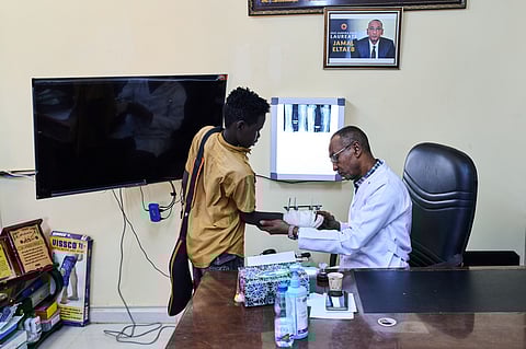 Dr. Jamal Eltaeb checks a patient at Al Nao Hospital in Omdurman, on the outskirts of Khartoum