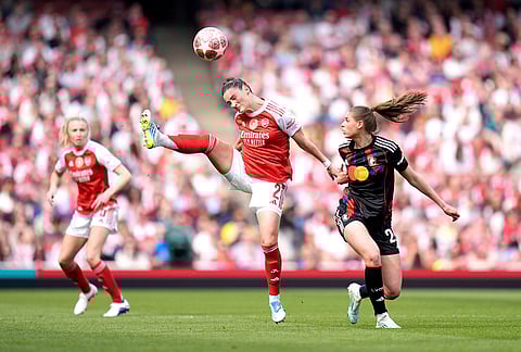Arsenal's Emily Fox, left, and OL Lyonnes' Jule Brand, right, challenge for the ball during the Women's Champions League semi-final, first leg soccer match between Arsenal and OL Lyonnes in London, England.