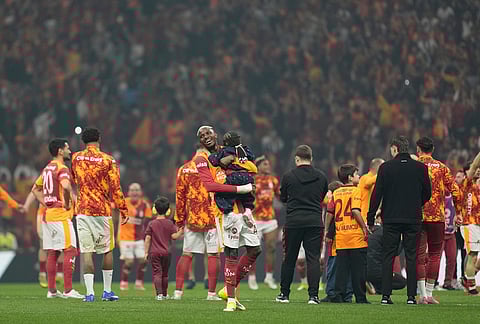 Galatasaray's players celebrate at the end of a Turkish Super Lig soccer match between Galatasaray and Fenerbahce in Istanbul, Turkey.