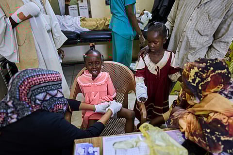 A nurse bandages a young patient injured by an unexploded ordnance blast at Al Nao Hospital in Omdurman, on the outskirts of Khartoum