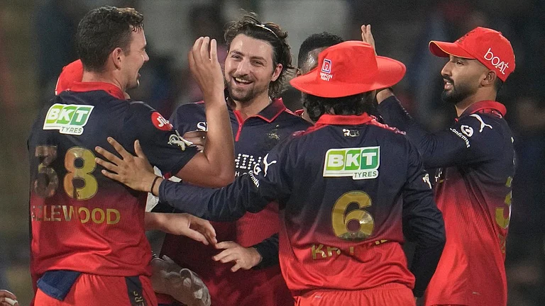Josh Hazlewood, left, celebrates with teammates the wicket of Nitish Rana during the Indian Premier League match between Delhi Capitals and Royal Challengers Bengaluru in Delhi. - AP/Manish Swarup