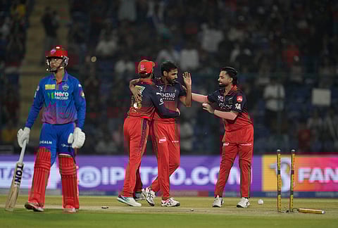 Royal Challengers Bengaluru's Bhuvneshwar Kumar, second right, celebrate with teammates the wicket of Delhi Capitals' Sahil Parakh, left, during the Indian Premier League cricket match between Delhi Capitals and Royal Challengers Bengaluru in Delhi.