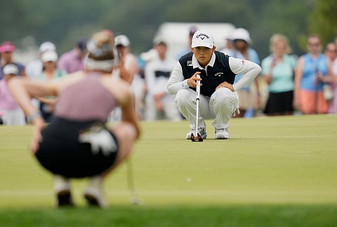 Ruoning Yin, of China, lines up a putt on the ninth hole during the final round of the Chevron Championship LPGA golf tournament in Houston.