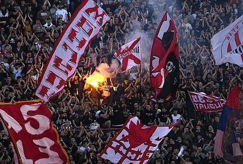 Red Star fans cheer during a Serbian National soccer league derby match between Red Star and Partizan in Belgrade, Serbia.