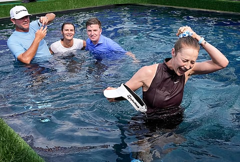 Nelly Korda celebrates by jumping in the water after winning the Chevron Championship LPGA golf tournament in Houston.