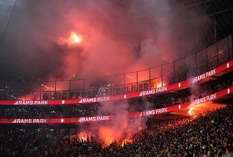 Fenerbahce's supporters light flares during a Turkish Super Lig soccer match between Galatasaray and Fenerbahce in Istanbul, Turkey.