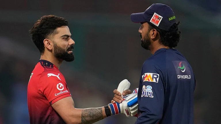 Virat Kohli, left, and KL Rahul chat during warm-ups before the start of the Indian Premier League match between Delhi Capitals and Royal Challengers Bengaluru in Delhi. - Photo: AP/Manish Swarup