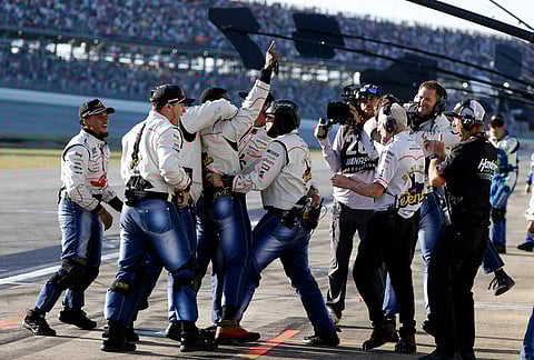 Crew of driver Carson Hocevar celebrate after a win during a NASCAR Cup Series auto race, in Talladega, Alabama.