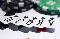 Royal Flush in Spades with poker chips