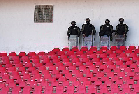 Serbian riot police officers stand guard during a Serbian National soccer league derby match between Red Star and Partizan in Belgrade, Serbia.