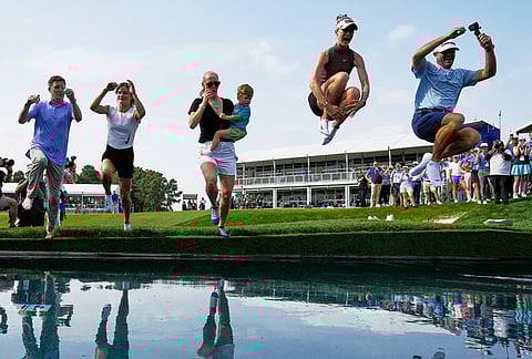 Nelly Korda celebrates by jumping in the water after winning the Chevron Championship LPGA golf tournament in Houston. 