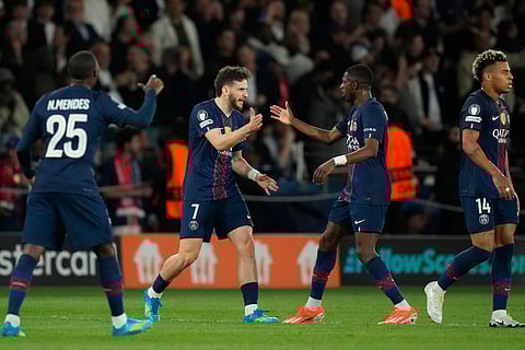 PSG's Khvicha Kvaratskhelia, second left, celebrates after scoring his side's first goal during the Champions League semifinal first leg soccer match between Paris Saint-Germain and Bayern Munich in Paris.