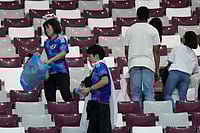 AP : Japanese fans clean up a stadium post an international match.