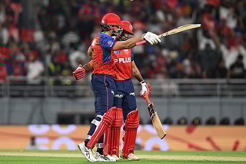 Punjab Kings' Marcus Stoinis, left, celebrates his fifty runs with his batting partner Suryansh Shedge during the Indian Premier League cricket match between Rajasthan Royals and Punjab Kings in New Chandigarh, India.