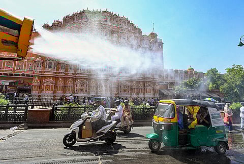 A Jaipur Smart City Ltd sprinkler truck sprays water on a hot summer day near Hawa Mahal, in Jaipur, Rajasthan.