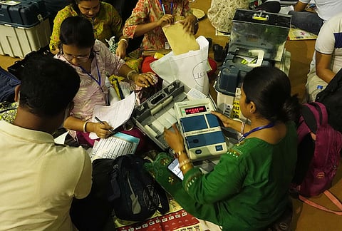 Polling officials check election materials for voting in the second phase of the West Bengal Assembly elections, at a distribution centre in Kolkata.