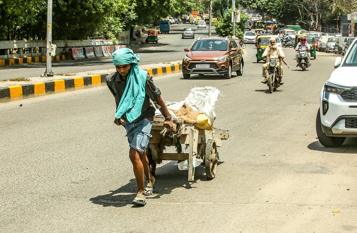 A porter pulling his cart in heatwave conditions