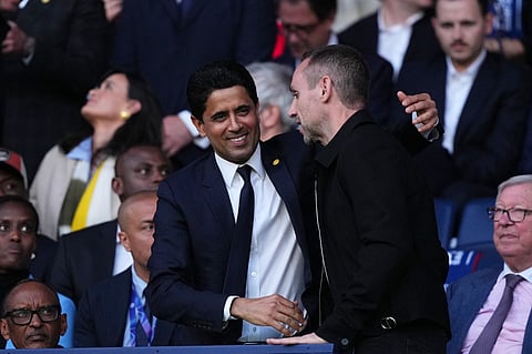 PSG President Nasser Al-Khelaifi, center, on the tribune before a Champions League semifinal, first leg, soccer match between Paris Saint-Germain and Bayern Munich in Paris.