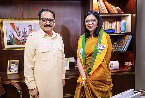 Delhi BJP president Virendra Sachdeva, left, poses for photographs with MP Swati Maliwal during her visit to state party office after joining the party, in New Delhi. 