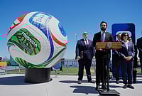 FIFA World Cup 2026: NYC Mayor Zohran Mamdani Announces Free Fan Events In The City | Photo: AP/Seth Wenig : New York City Mayor Zohran Mamdani, second from left, speaks next to a large soccer ball during a news conference in the Staten Island borough of New York.