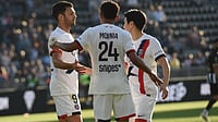 | Photo: AP/Mathieu Pattier : PSG's Senny Mayulu, center, celebrates with PSG's Goncalo Ramos, left, and PSG's Lee Kang-in, right, after scoring his side's second goal during the French League One soccer match between Angers and Paris Saint-Germain in Angers, western France, Saturday, April 25, 2026.