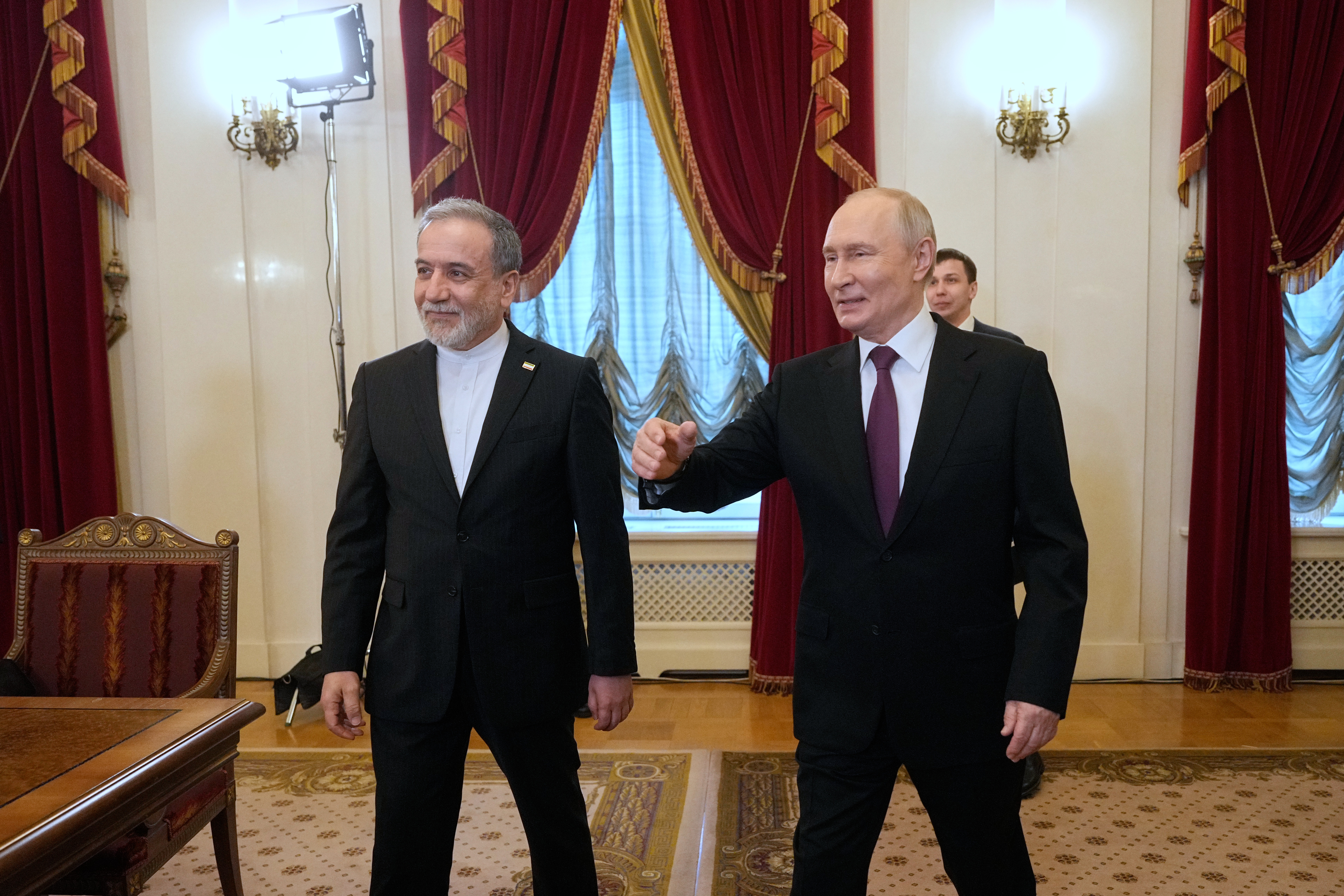 Iran Plays Hormuz Card: De-escalation Or Missed Opportunity? AP Photo/Dmitri Lovetsky : Russian President Vladimir Putin, right, and Iranian Foreign Minister Abbas Araghchi walk to attend the talks at the Boris Yeltsin Presidential Library, in St. Petersburg, Russia.