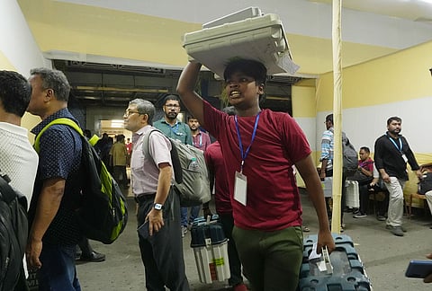 Polling officials leave for their respective booths after collecting Electronic Voting Machine (EVM) and Voter Verifiable Paper Audit Trail (VVPAT) units on the eve of second phase of voting in the West Bengal Assembly elections, in Kolkata.