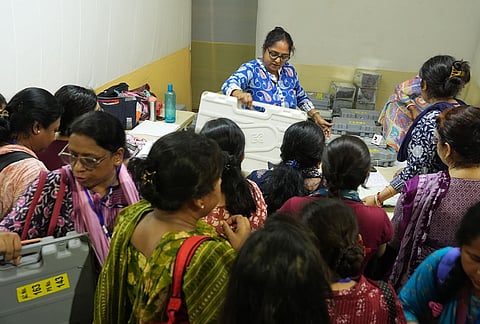 Polling officials check election materials for voting in the second phase of the West Bengal Assembly elections, at a distribution centre in Kolkata.