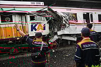 AP : Workers examine the wreckages of trains after a collision in Bekasi, Indonesia