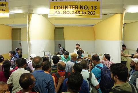 Polling officials collect Electronic Voting Machine (EVM) and Voter Verifiable Paper Audit Trail (VVPAT) units at a distribution centre on the eve of second phase of voting in the West Bengal Assembly elections, in Kolkata.