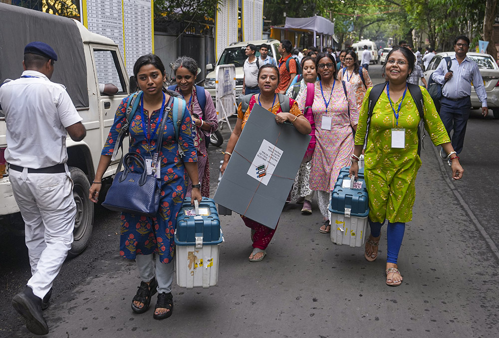 Officials leave for their respective polling stations after collecting Electronic Voting Machine (EVM) and Voter Verifiable Paper Audit Trail (VVPAT) units for voting in the second phase of the West Bengal Assembly elections, in Kolkata. - | Photo: PTI/Manvender Vashist Lav